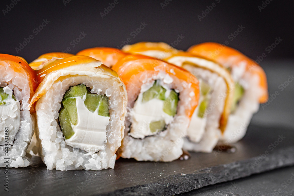 appetizing sushi roll philadelphia with eel cucumber and unagi on a black stone plate appetizing sushi roll philadelphia with eel cucumber and unagi on a black stone plate