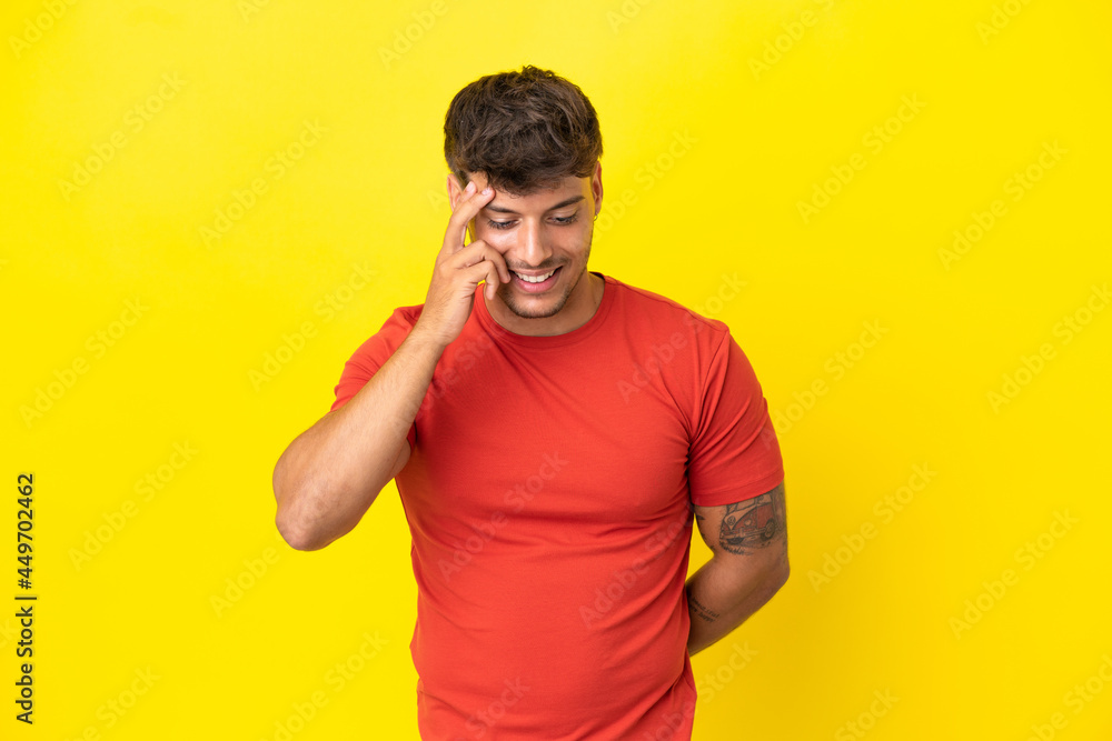 Young caucasian handsome man isolated on yellow background laughing Young caucasian handsome man isolated on yellow background laughing