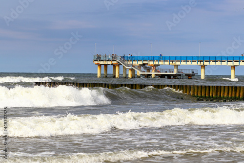 Pier in the city of Zelenogradsk during a storm. Waves in the Baltic Sea © Adriana