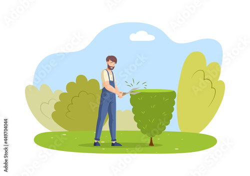 Male bearded gardener in overalls trimming tree working at garden cutting green plant
