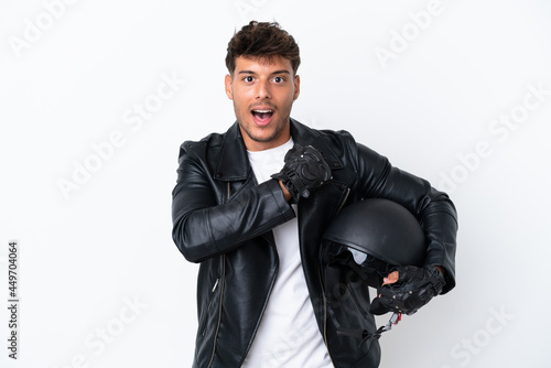 Young caucasian man with a motorcycle helmet isolated on white background celebrating a victory