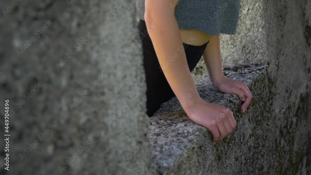 person climbing on a stone wall person climbing on a stone wall