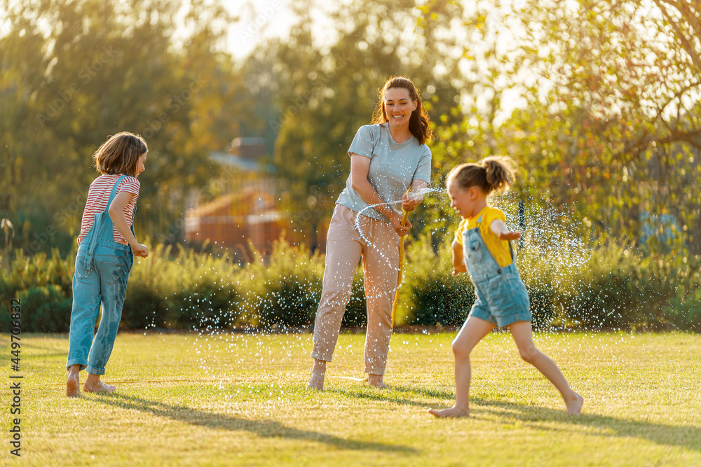 Fototapeta premium Happy family playing in backyard