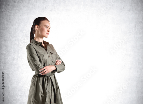 Confident attractive woman in casual hacky dress in crossed arm photo