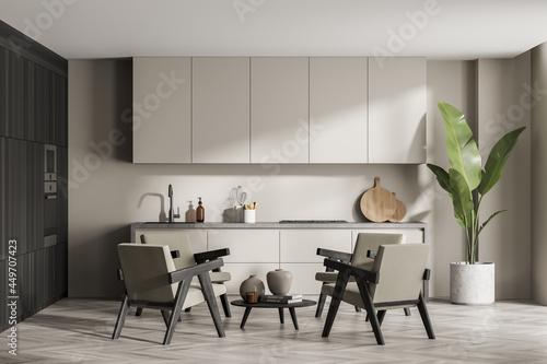 Beige kitchen with four armchairs and dark wood deatils photo