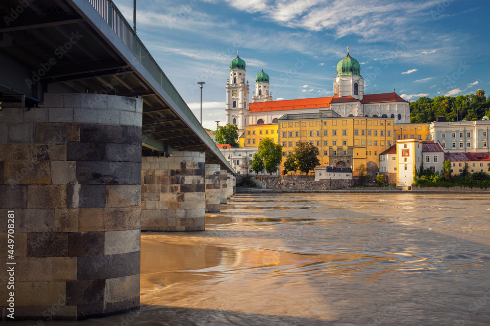Passau, Germany. Cityscape image of Passau with the St. Stephan's Cathedral and Mary's Bridge or Mariensbrucke over Inn River at sunny summer day.