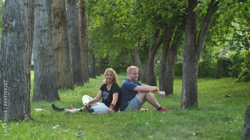 Happy Mature Mother with Grown-up Adult Son Resting in a Summer City Park. Bonding and Family Reunion, Mothers Day Concept Happy Mature Mother with Grown-up Adult Son Resting in a Summer City Park. Bonding and Family Reunion, Mothers Day Concept