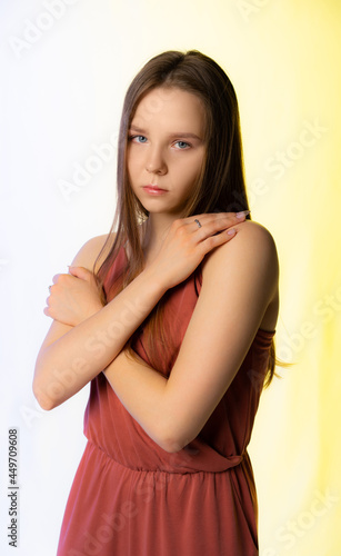 portrait of a girl with white flowers. multicolored light on background and face
