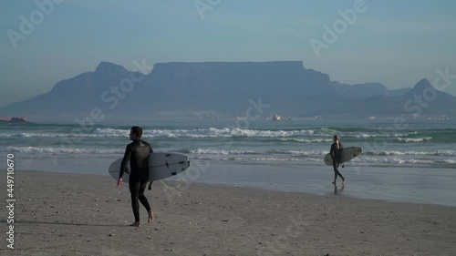 Surfer walking on the beach in Cape Town. South Africa