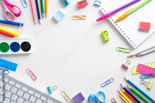 Flat lay colorful school supplies on white background. Back to school concept. Top view, overhead.