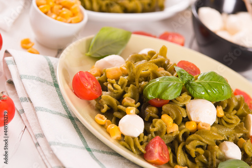 Fusilli pasta with cherry tomatoes and sweet corn.