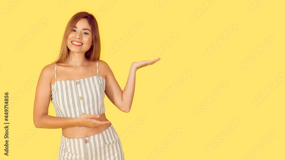 A smiling young professional helps to find the destination, showing the way, pointing to the left and smiling friendly, happy to answer any questions like introducing new product, yellow background A smiling young professional helps to find the destination, showing the way, pointing to the left and smiling friendly, happy to answer any questions like introducing new product, yellow background