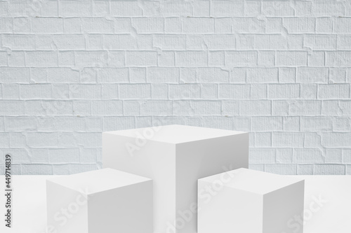 Display product stand, Three white block box podium on white paint bricks background. 3D rendering illustration