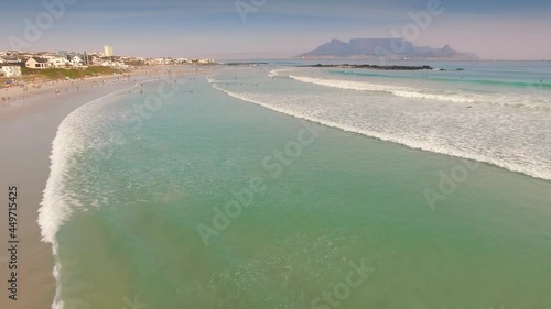 Aerial: People on the beach and swimming in the Ocean. Cape Town, South Africa