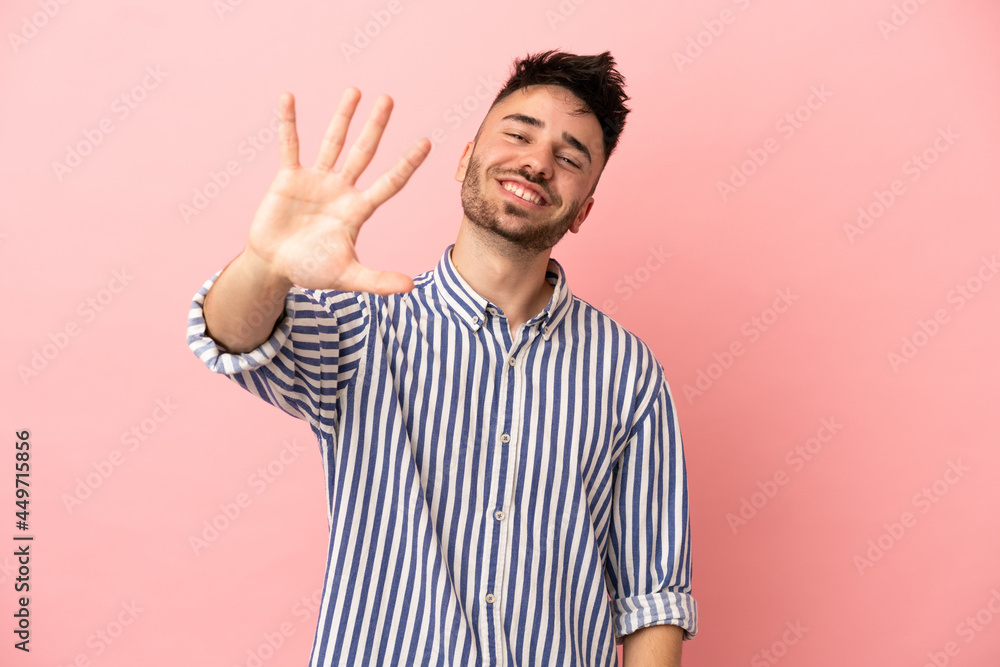 Young caucasian man isolated on pink background counting five with fingers Young caucasian man isolated on pink background counting five with fingers