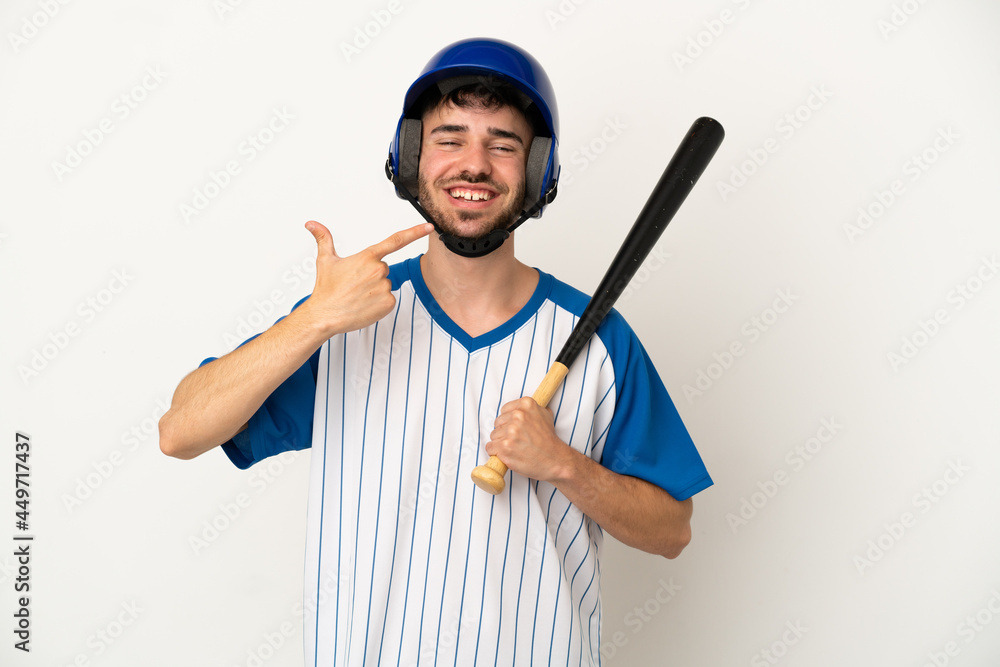 Young caucasian man playing baseball isolated on white background giving a thumbs up gesture Young caucasian man playing baseball isolated on white background giving a thumbs up gesture