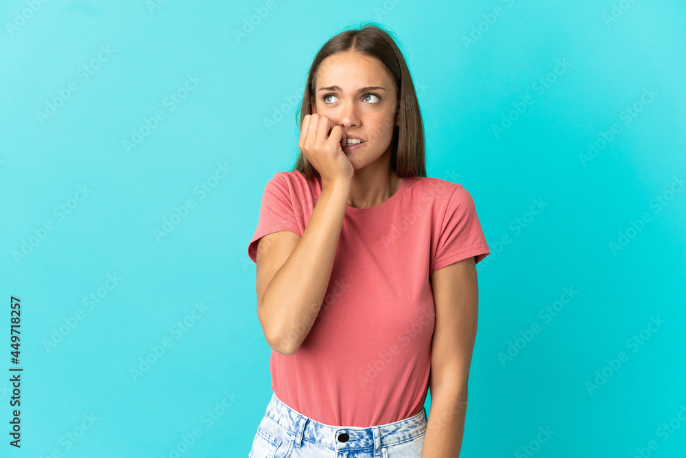 Young woman over isolated blue background is a little bit nervous Young woman over isolated blue background is a little bit nervous