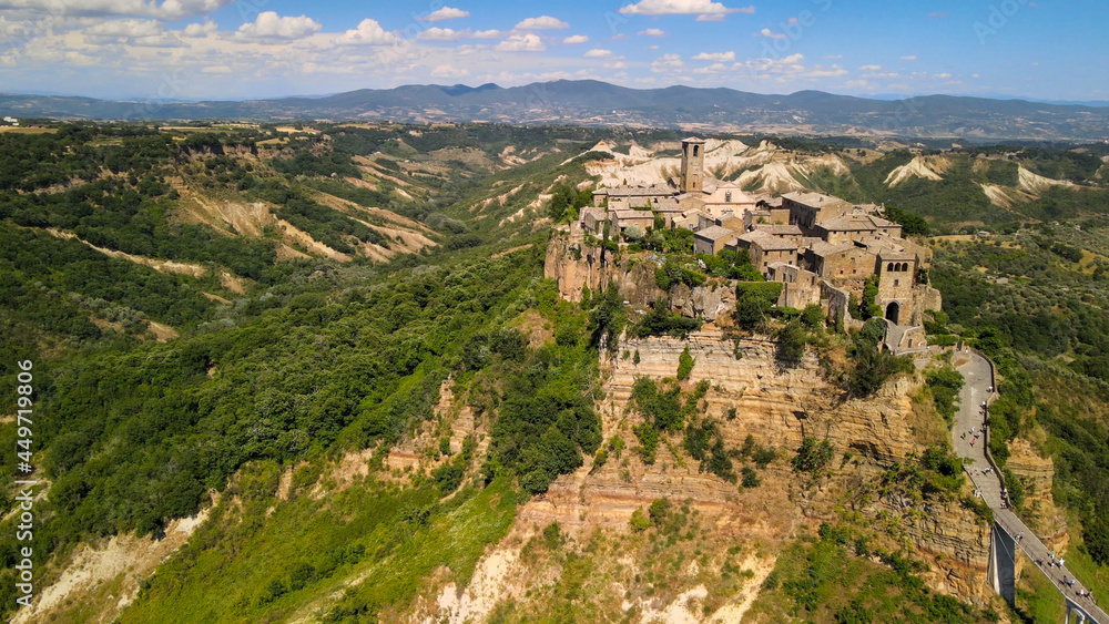 Panoramic aerial view of Civita di Bagnoregio from a flying drone around the medieval city, Italy.