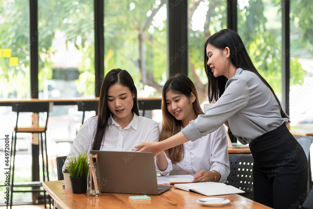 Team of young Asian businesswoman consulting and brainstorming together using a laptop for documents placed at the office. Team of young Asian businesswoman consulting and brainstorming together using a laptop for documents placed at the office.