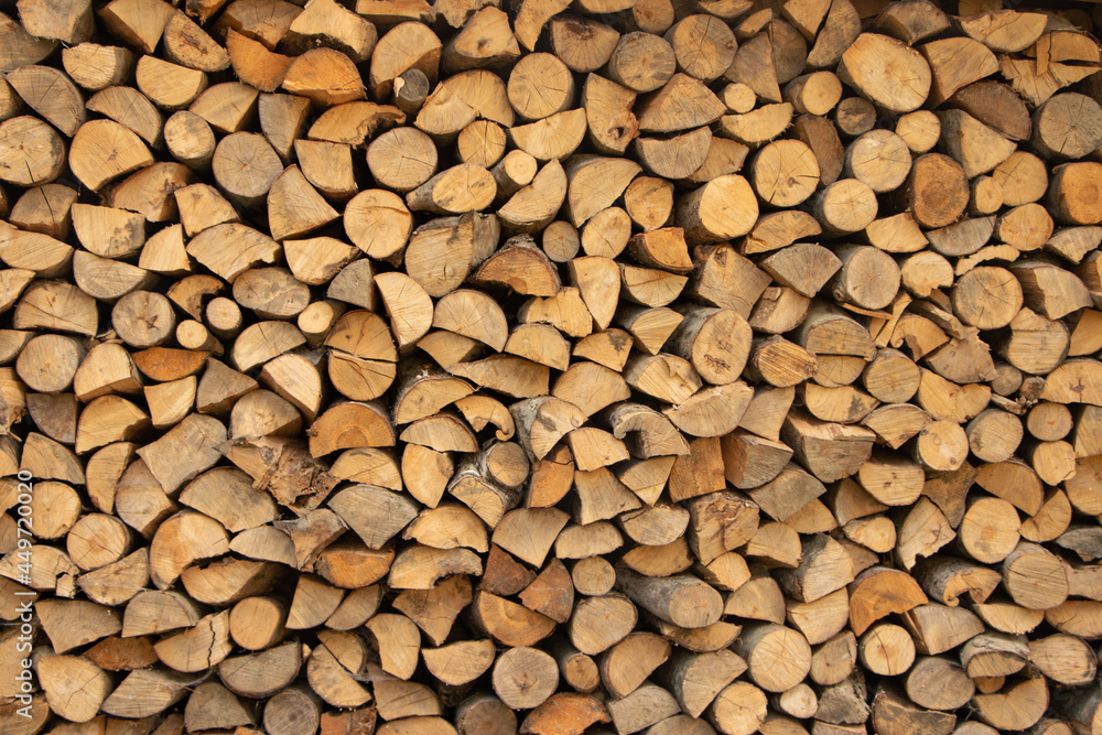 Wall firewood, Background of dry chopped firewood logs in a pile Wall firewood, Background of dry chopped firewood logs in a pile
