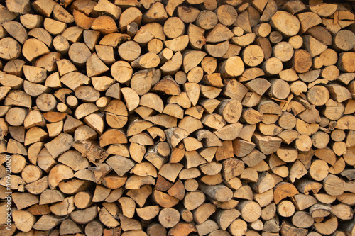 Wall firewood, Background of dry chopped firewood logs in a pile