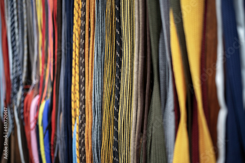 Lots of multicolored shoelaces displayed for sale on the street