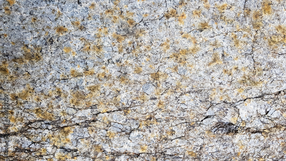 Naklejka premium surface of the marble with brown tint. Details of sand stone texture, close up shot of rock surface with vignette at cover and bright spot at centre, idea for background or backdrop.