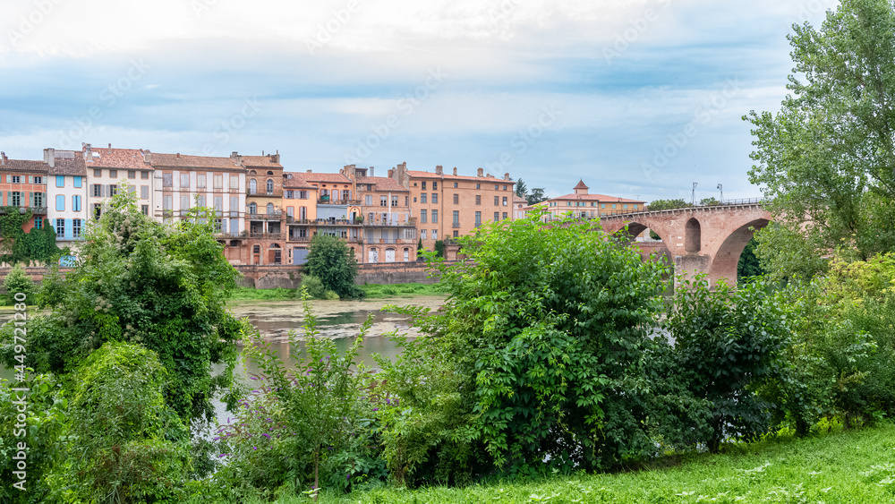 Montauban, beautiful french city in the South, old bridge on the river Tarn, and colorful houses
