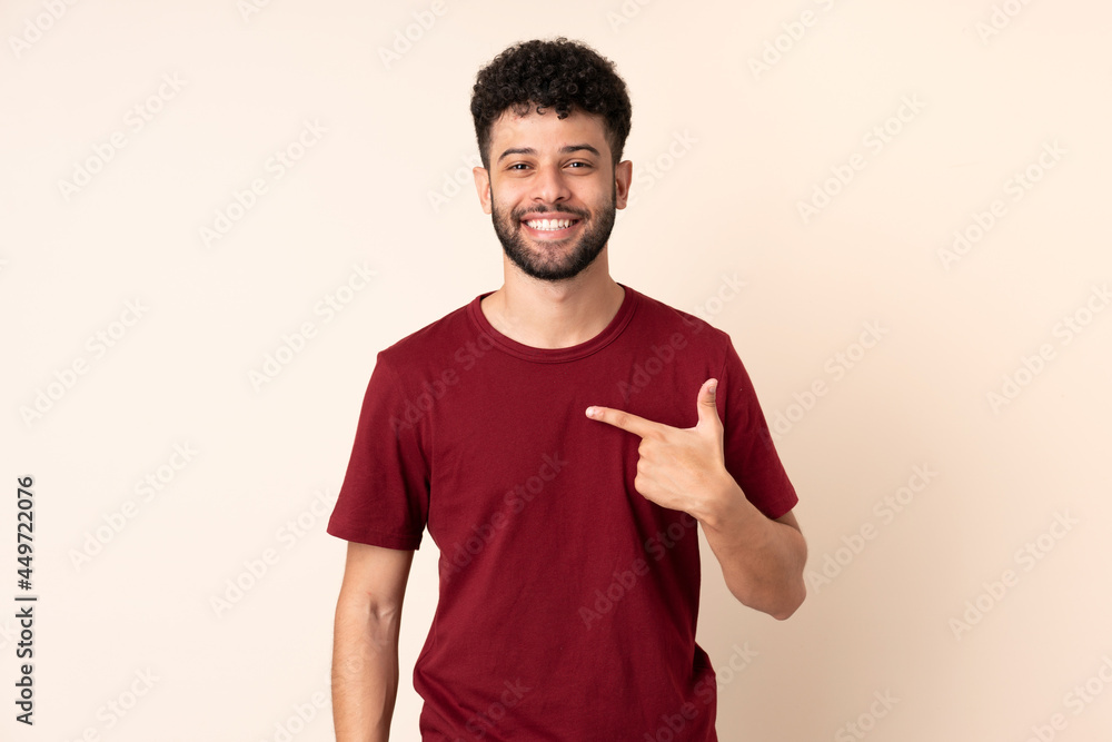 Young Moroccan man isolated on beige background pointing to oneself Young Moroccan man isolated on beige background pointing to oneself
