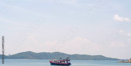 boat on the sea with sky and mountain view