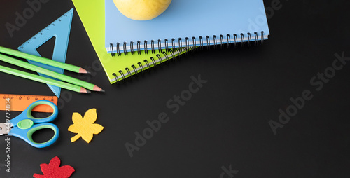 Art supplies and school supplies on a black school board. View from above. Place for your text.