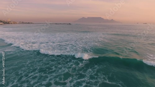 Aerial: Waves Crashing on tropical beach at sunset. Cape Town, South Africa