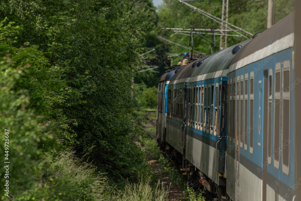 Naklejka premium Electric engine and blue coach from window