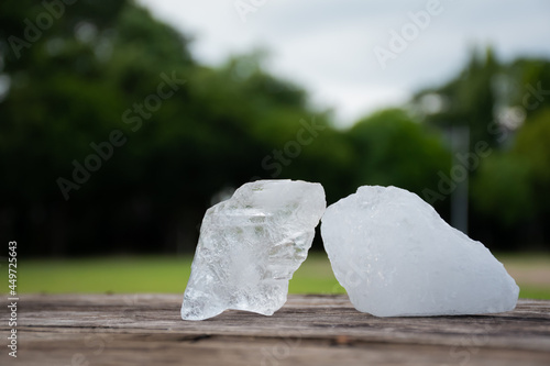 Alum cubes on wooden table, blurred background, concept for using alum with human body to be alternative medical health prodects. photo