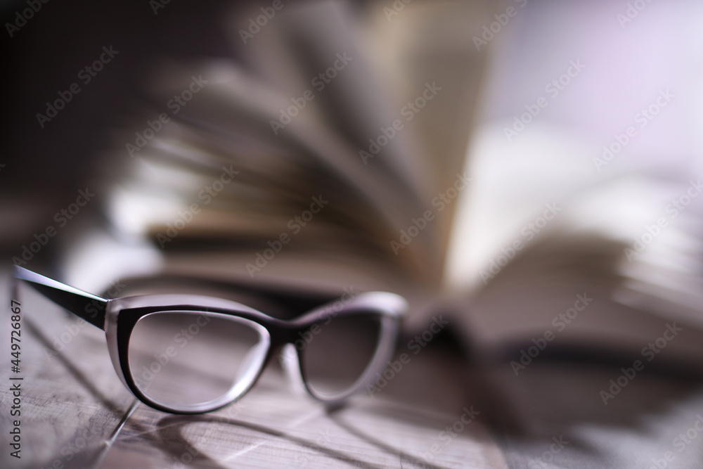 Composition with glasses and open book on the table Composition with glasses and open book on the table