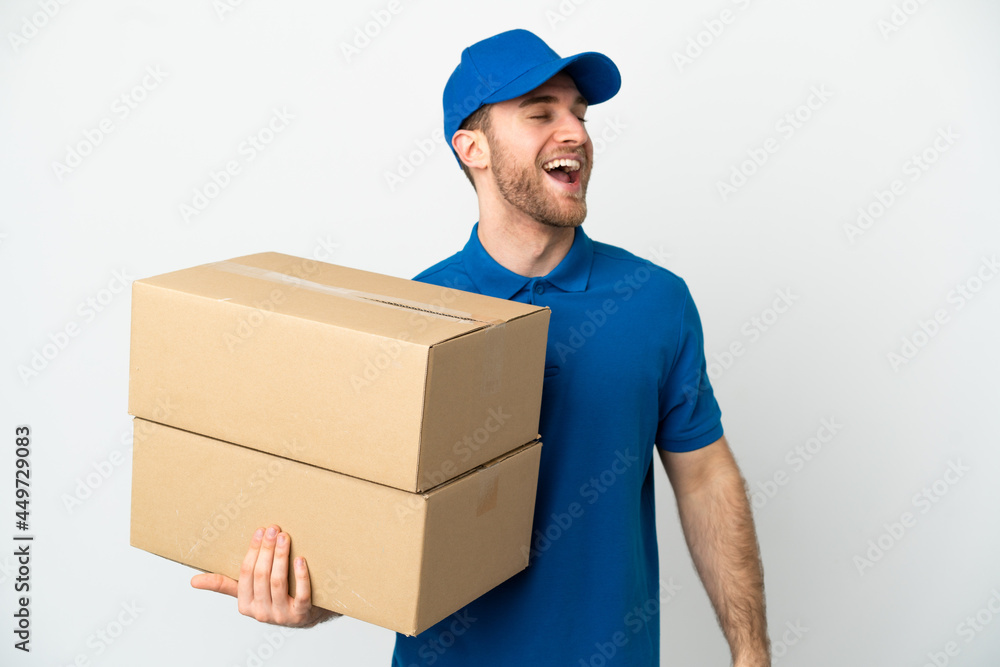 Delivery man over isolated white background laughing Delivery man over isolated white background laughing