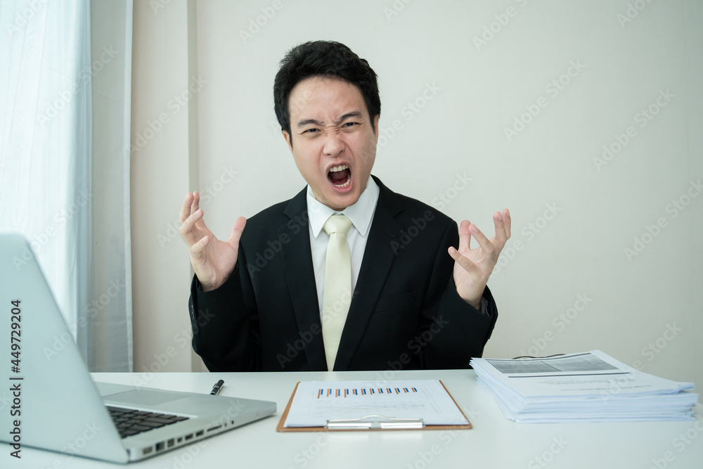 Unhappy Asian young businessman feels very upset and despair. Unhappy Asian young businessman feels very upset and despair.