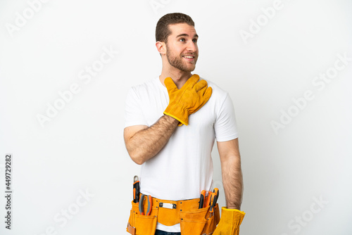 Young electrician man over isolated white wall looking up while smiling