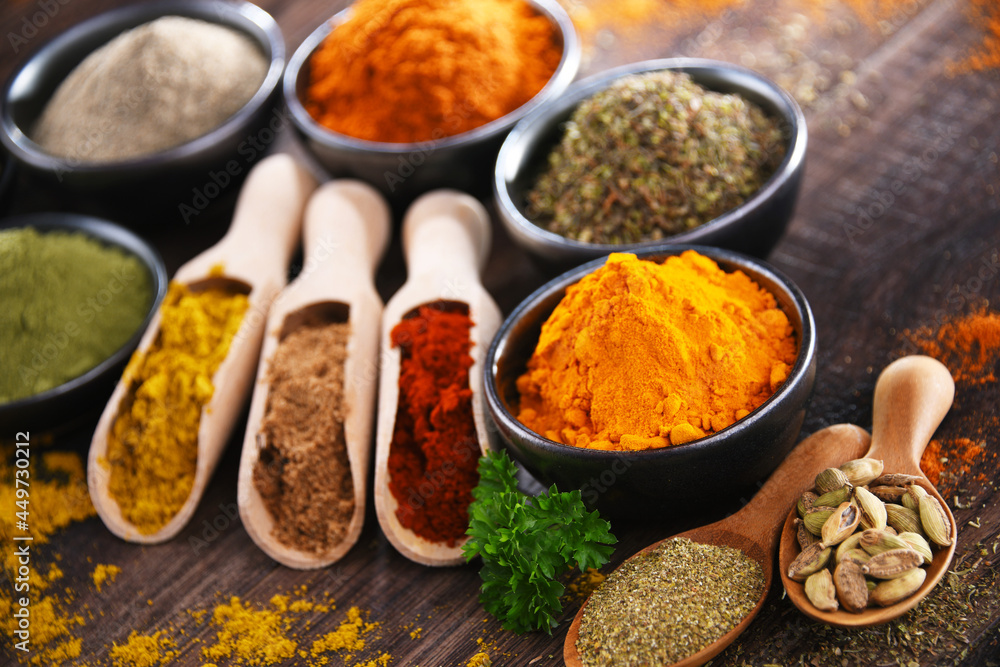 Variety of spices on wooden kitchen table. Variety of spices on wooden kitchen table.