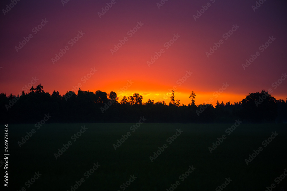 A beautiful evening scenery of a rural landscape. Sunset in the country landscape. Summertime scenery of Northern Europe.