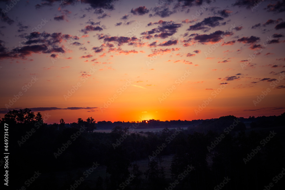 A beautiful evening scenery of a rural landscape. Sunset in the country landscape. Summertime scenery of Northern Europe.