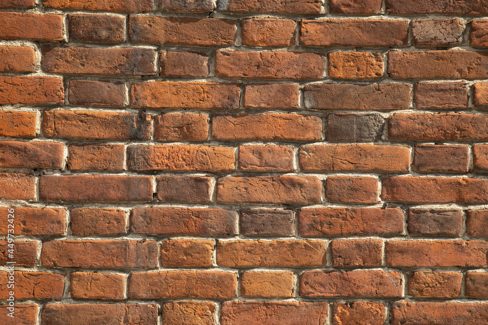 An old brick wall of the 19th century.The background of an old brick wall. An old brick wall of the 19th century.The background of an old brick wall.