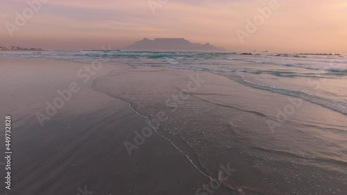 Aerial: Waves Crashing on tropical beach at sunset. Cape Town, South Africa