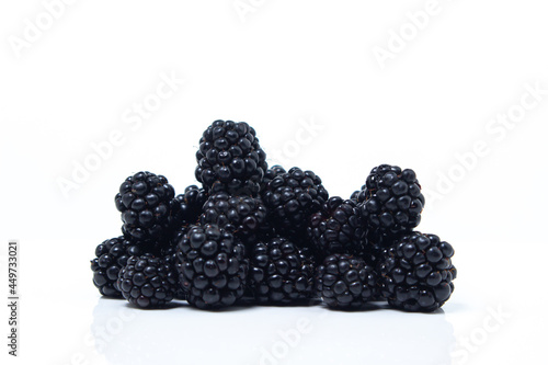 A bunch of blackberries on a white background. Delicious ripe berry