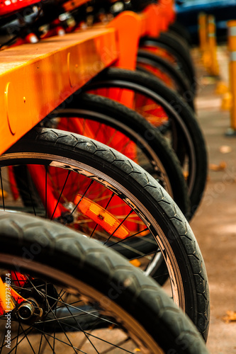 Macro closeup of rental bicycle wheels in row