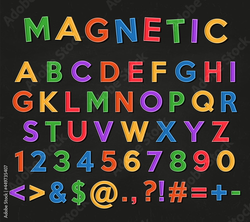 Alphabet, numbers and symbols. Colored magnets letters and numbers on a black school chalkboard background.