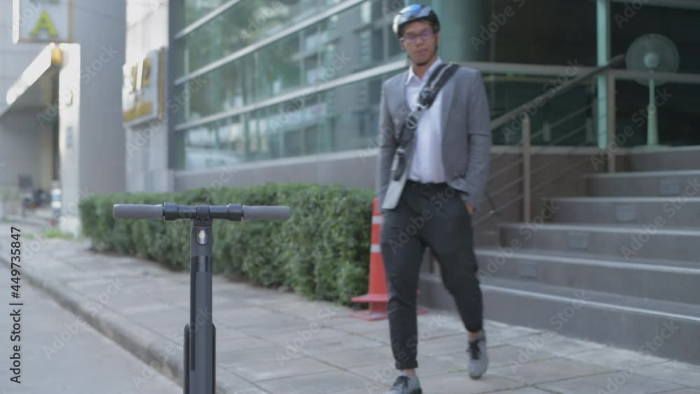 Energy efficient travel vehicle concept of 4k Resolution. A business man riding a scooter in the city. Energy efficient travel vehicle concept of 4k Resolution. A business man riding a scooter in the city.