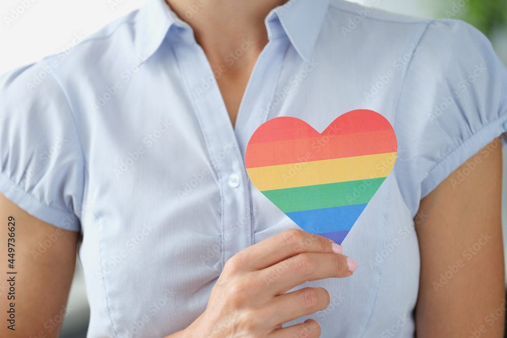 Woman holding multi colored lgbt heart closeup Woman holding multi colored lgbt heart closeup