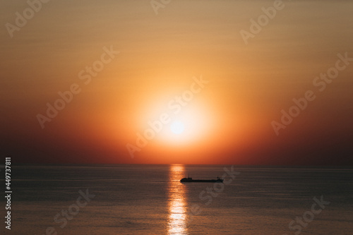 silhouette of a cargo ship at sunset