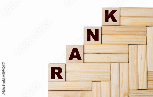 On a light background, wooden blocks and cubes with the text RANK